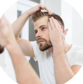 man standing in a mirror examining his hairline 768x768.jpg.webp