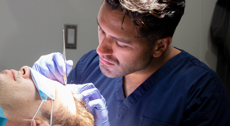 Doctor Sharma performing a hair transplant at the alberta hair institute