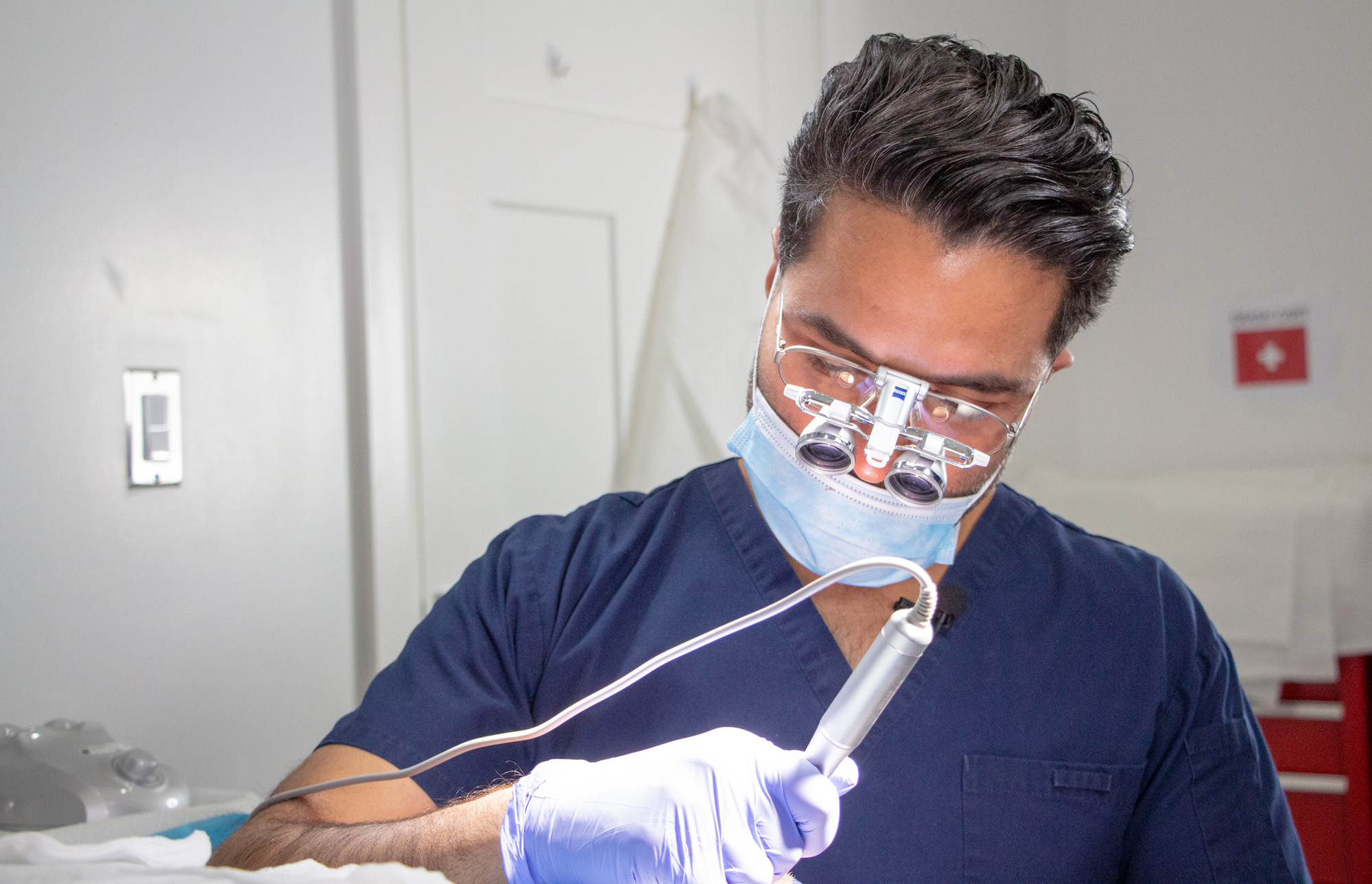 Dr Sharma doing a hair transplant in Blue